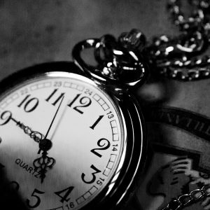 grayscale photography of analog pocket watch