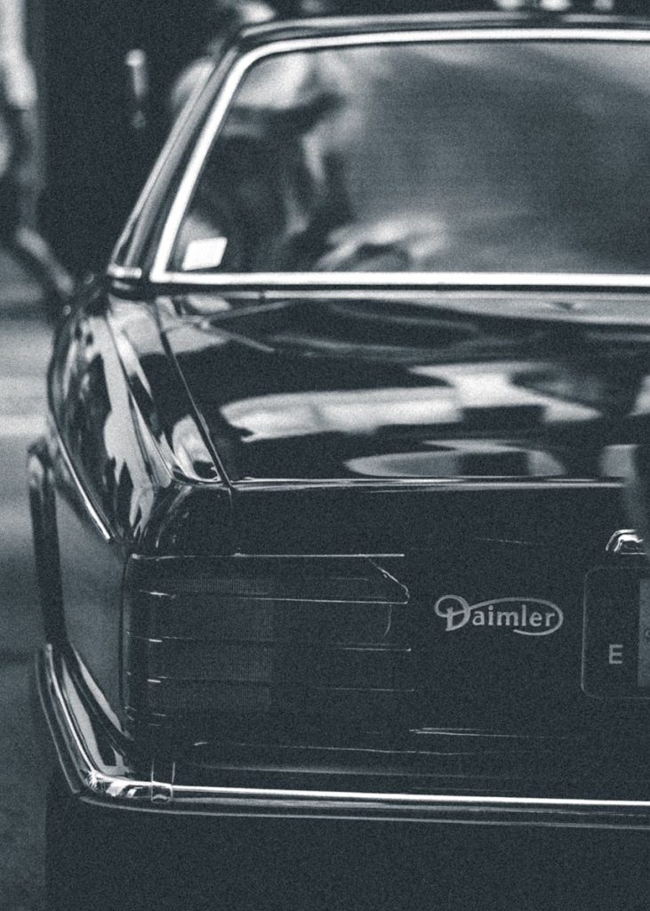 Classic Daimler car showcasing its elegant design in a vintage black and white photo.